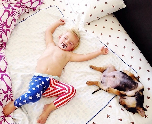 Toddler sleeping with dog