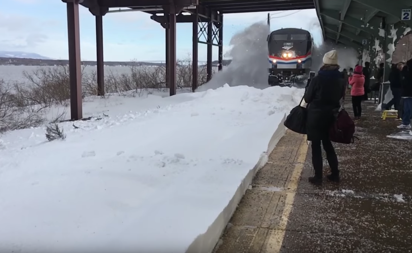 Train arriving at snow filled station