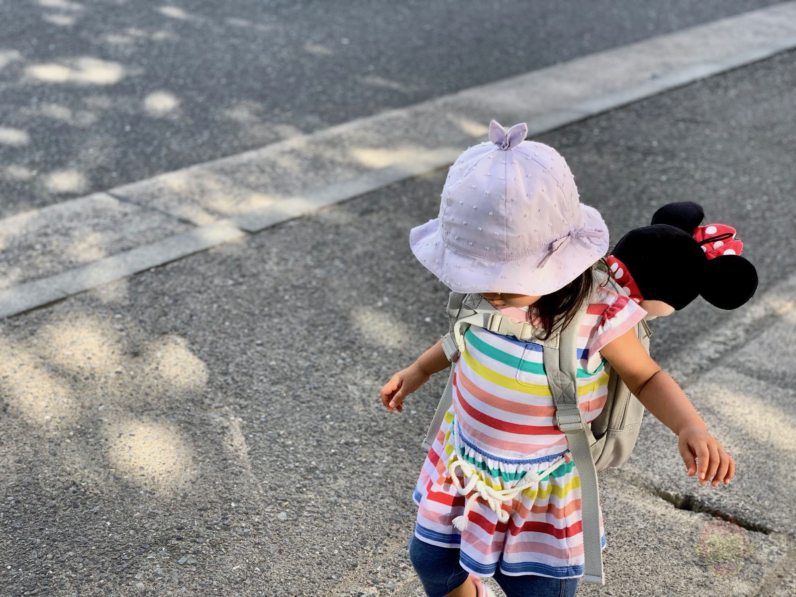 Daughter walking with minnie in her backpack 01